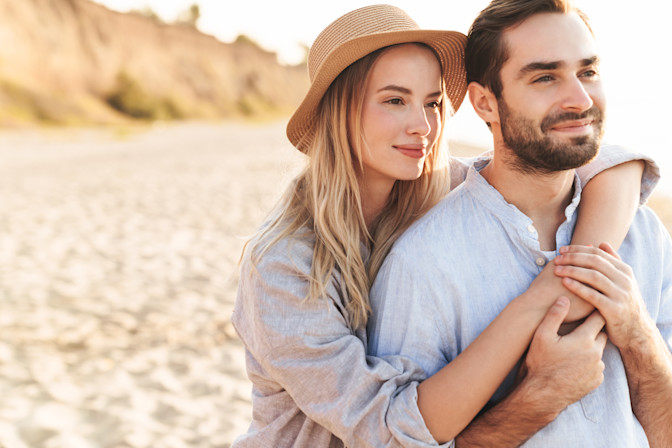 Happy couple on the beach with prescription sunglasses